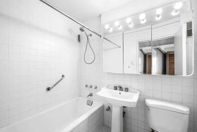 a bedroom with a large bed and windows