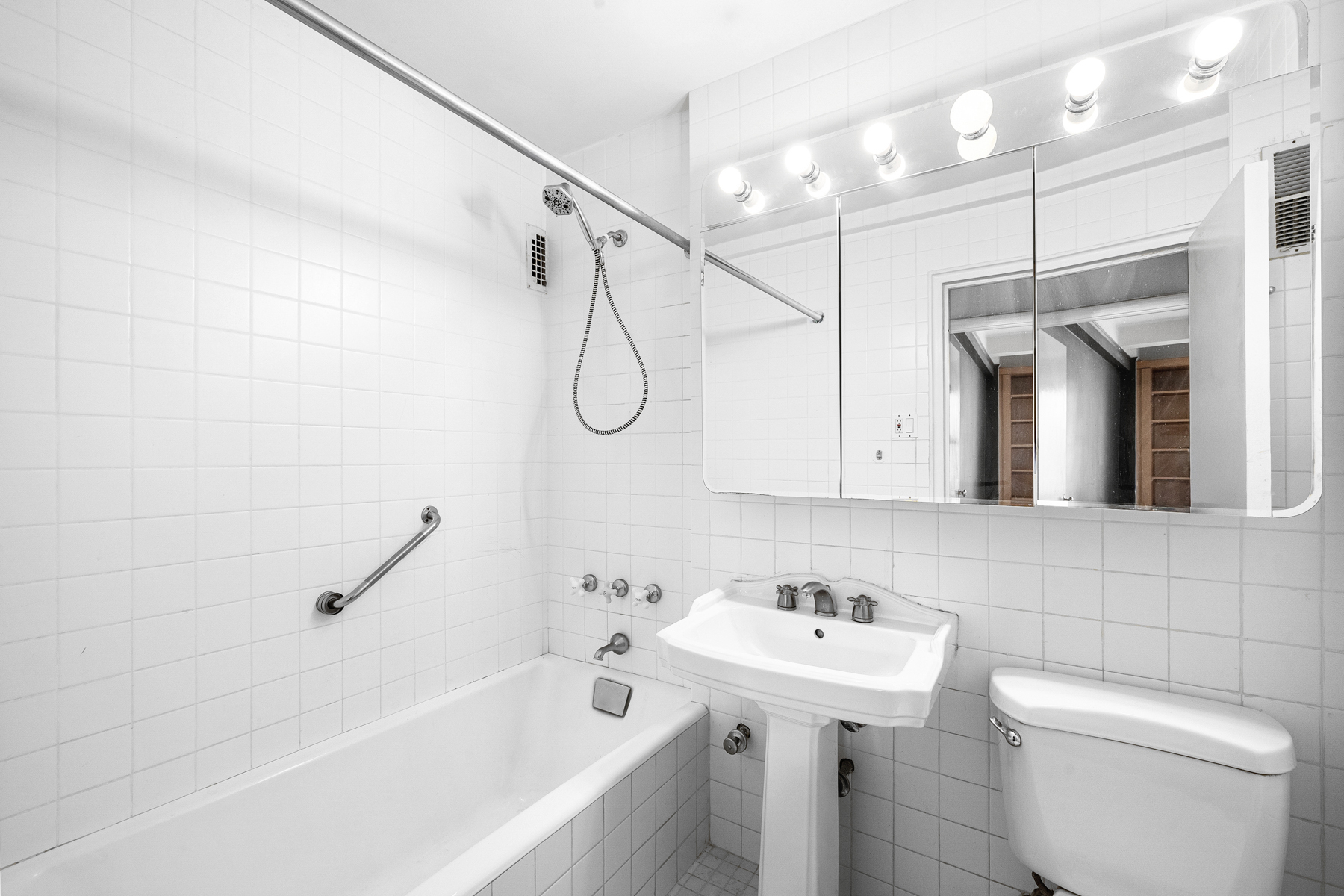 123 East 37th Street, Unit 10E Manhattan, NY 10016 - Photo 12 of 18 a bathroom with a sink a toilet and a bathtub