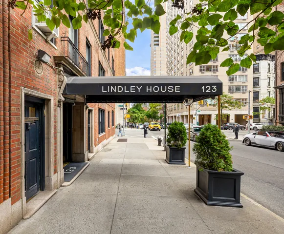 a living room with furniture a fireplace and a painting on the wall