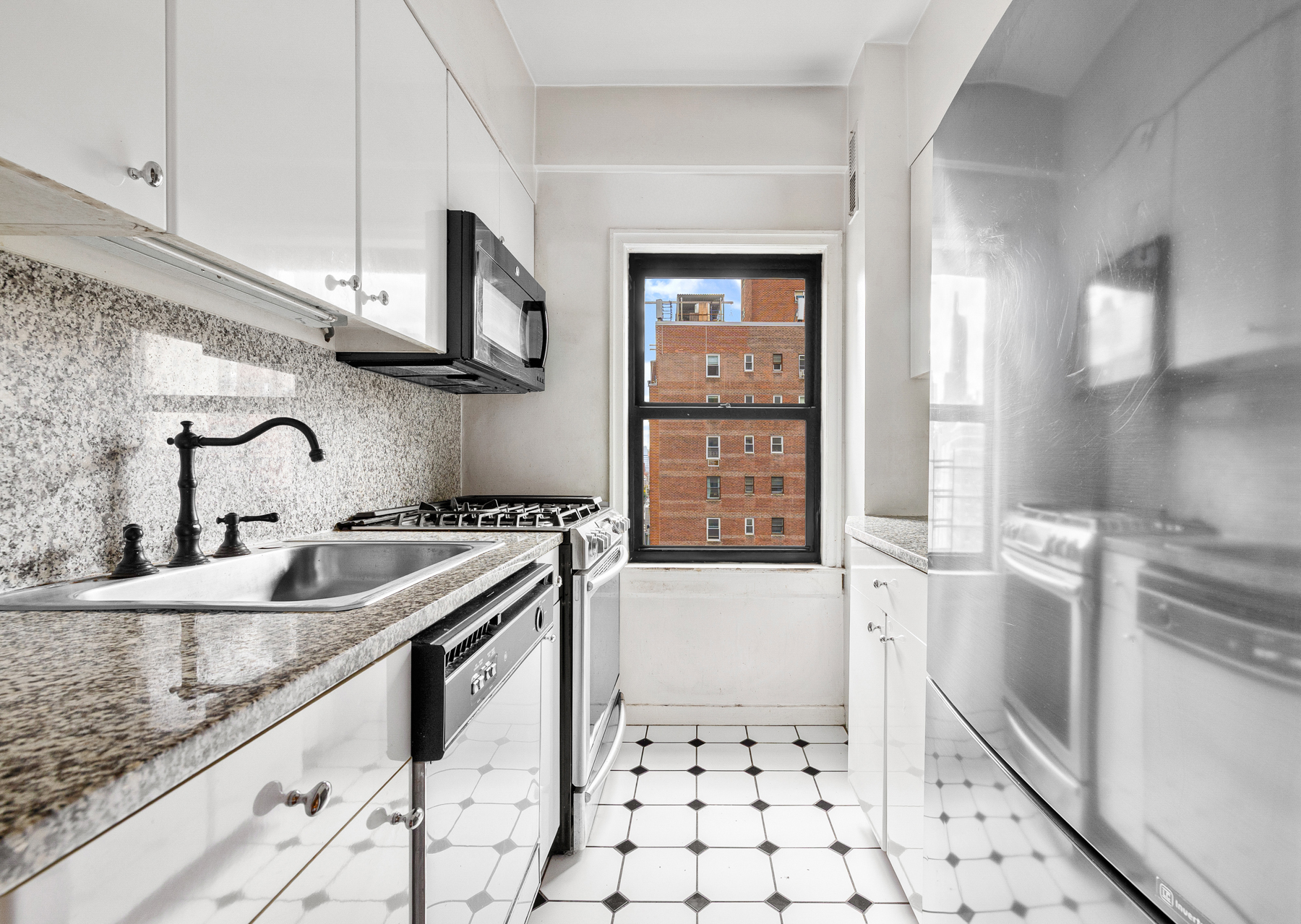 123 East 37th Street, Unit 10E Manhattan, NY 10016 - Photo 9 of 18 a kitchen with stainless steel appliances granite countertop a sink and a refrigerator