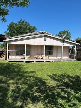 a front view of a house with a yard table and chairs