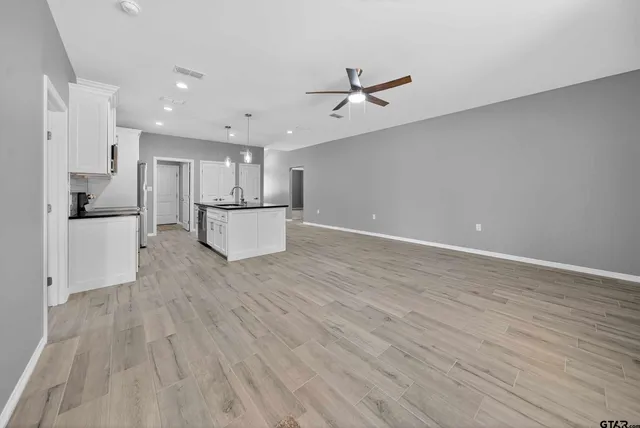 a view of a kitchen with a dishwasher and wooden floor