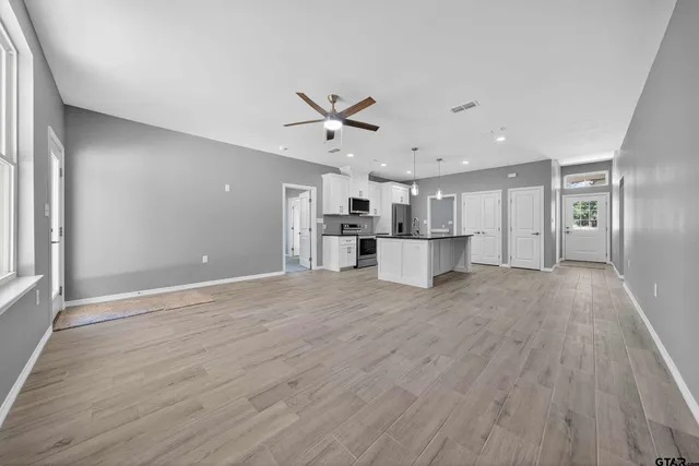 a view of a kitchen with a sink and a refrigerator