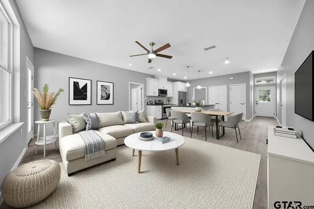 a living room with furniture a view of bedroom and a window