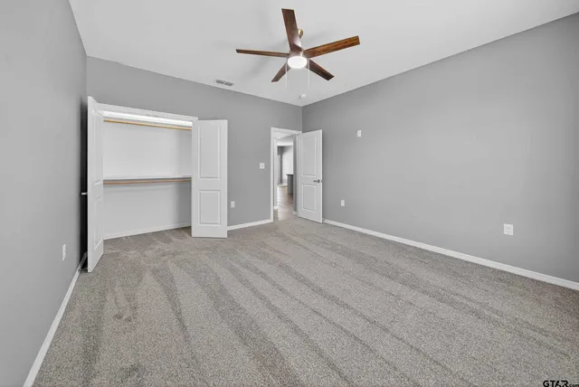 an empty room with a empty space and a ceiling fan