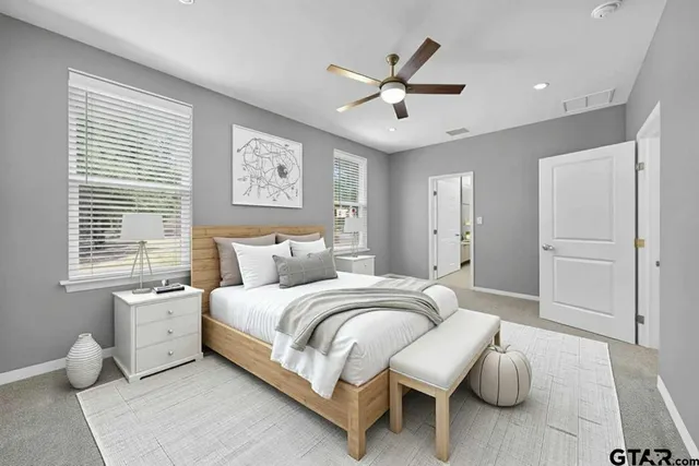 a spacious bedroom with a bed and a window