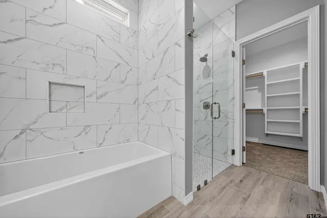 a bathroom with a bathtub and a shower