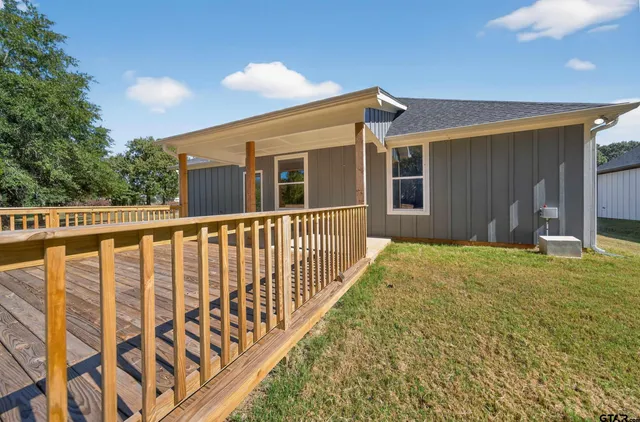 a porch with a table and chairs