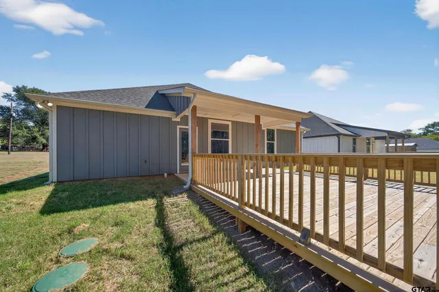 a view of a house with wooden fence