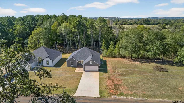 an aerial view of a house with a yard