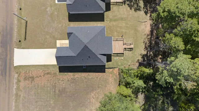 an aerial view of a house with a yard
