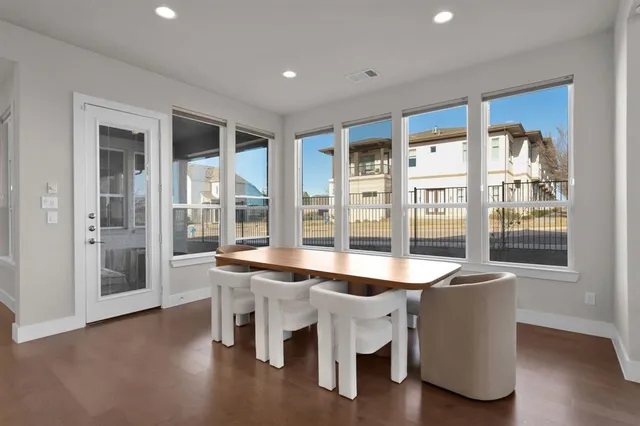 a dining hall with stainless steel appliances granite countertop a granite counter tops and a large window