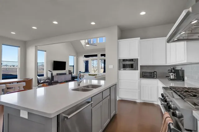 a kitchen with a sink a stove and cabinets