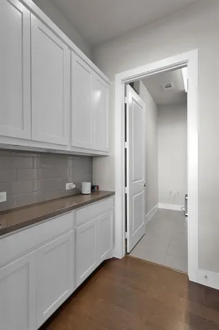 a kitchen with white cabinets and a sink