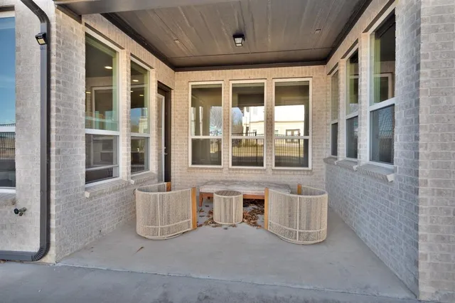 a balcony with table and chairs
