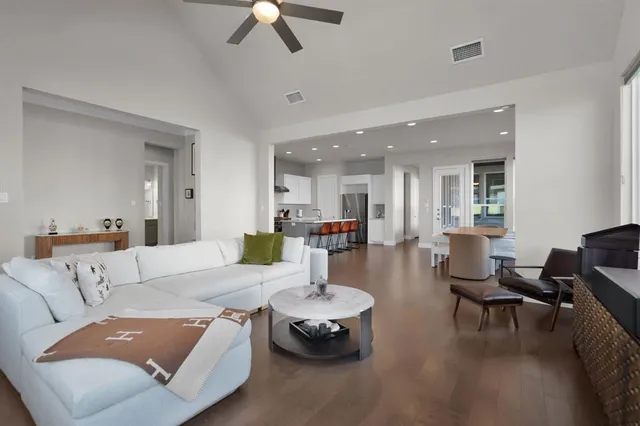 a living room with furniture and a chandelier