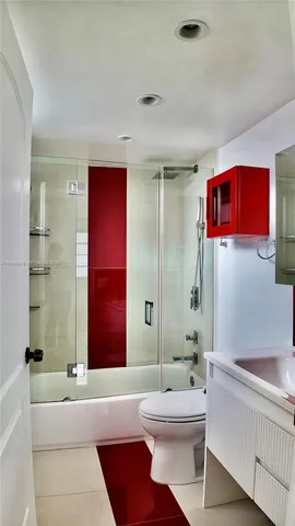 a bathroom with a bathtub shower sink mirror and toilet