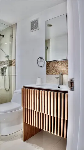 a bathroom with a glass shower door
