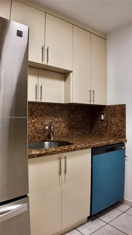 a kitchen with granite countertop white cabinets and a stove top oven