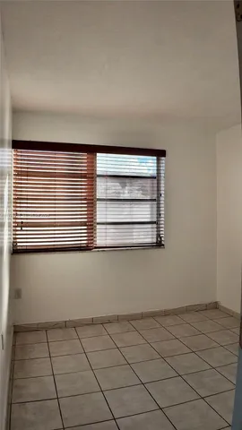 a view of an empty room and wooden floor