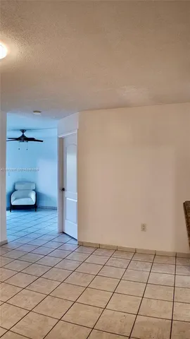 a bathroom with a granite countertop sink and a refrigerator