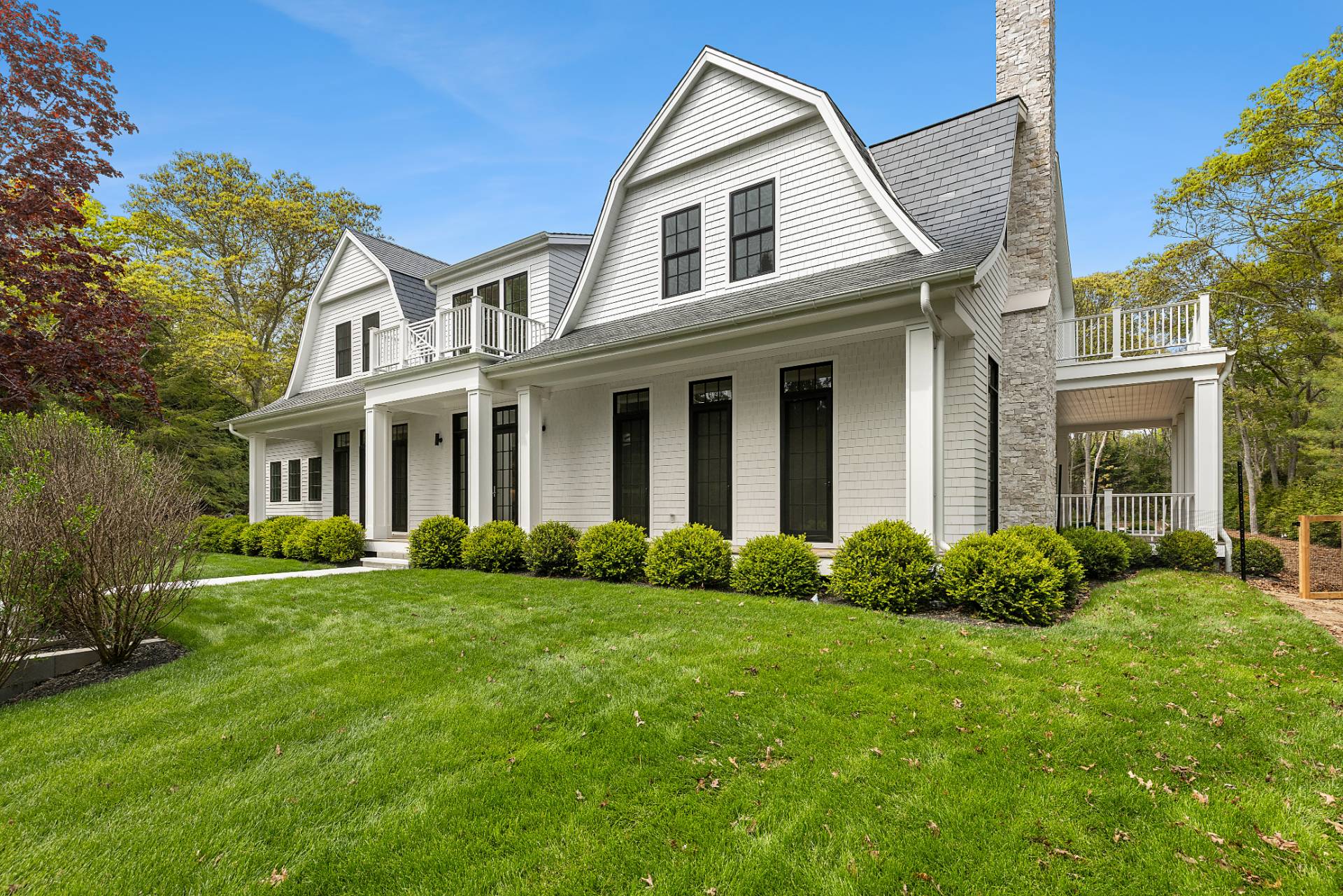 73 Wainscott Stone Road Wainscott, NY 11975 - Photo 2 of 27 a front view of a house with a yard