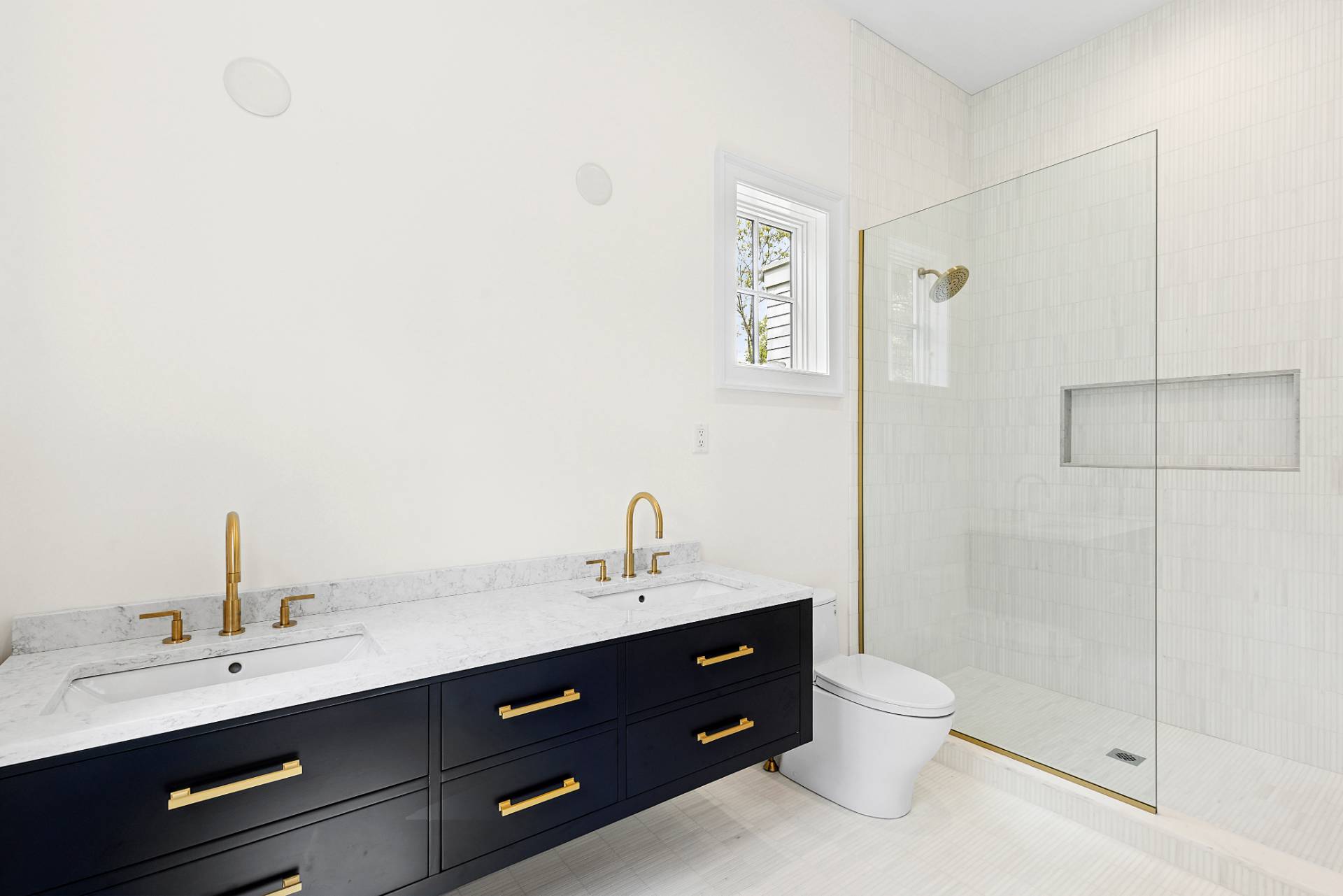 73 Wainscott Stone Road Wainscott, NY 11975 - Photo 23 of 27 a bathroom with a double vanity sink toilet and shower