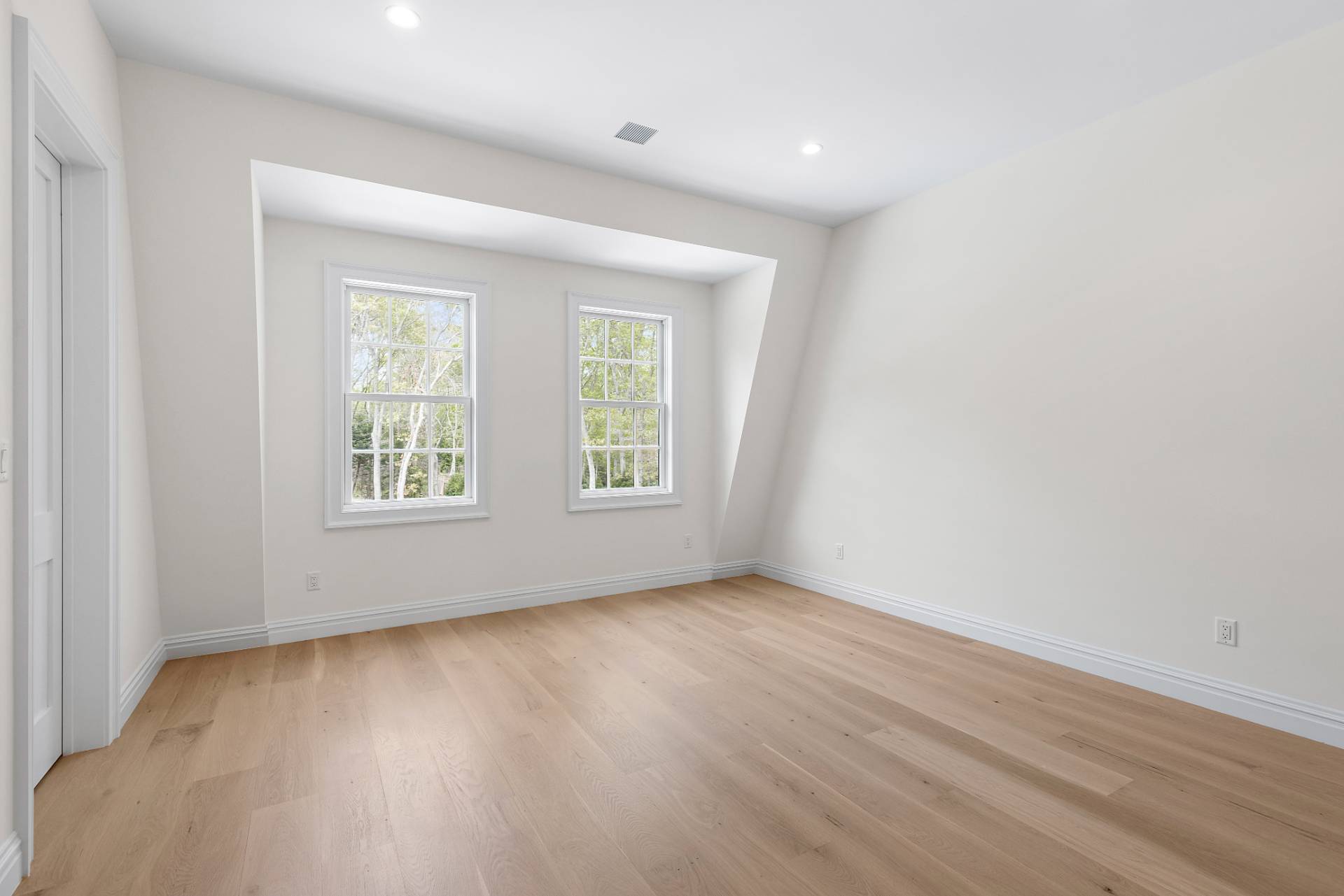 73 Wainscott Stone Road Wainscott, NY 11975 - Photo 24 of 27 an empty room with wooden floor and windows