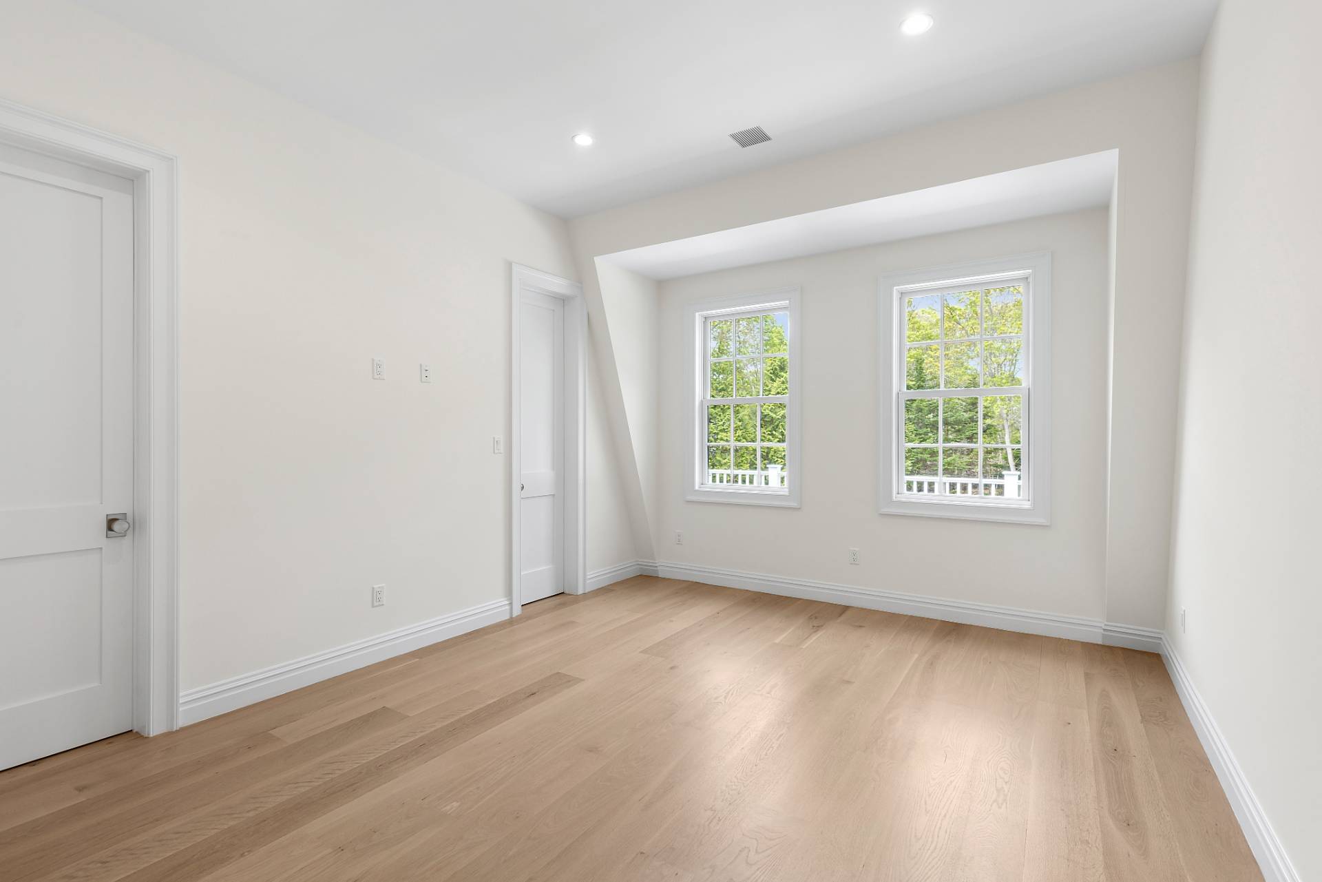 73 Wainscott Stone Road Wainscott, NY 11975 - Photo 26 of 27 an empty room with wooden floor and windows