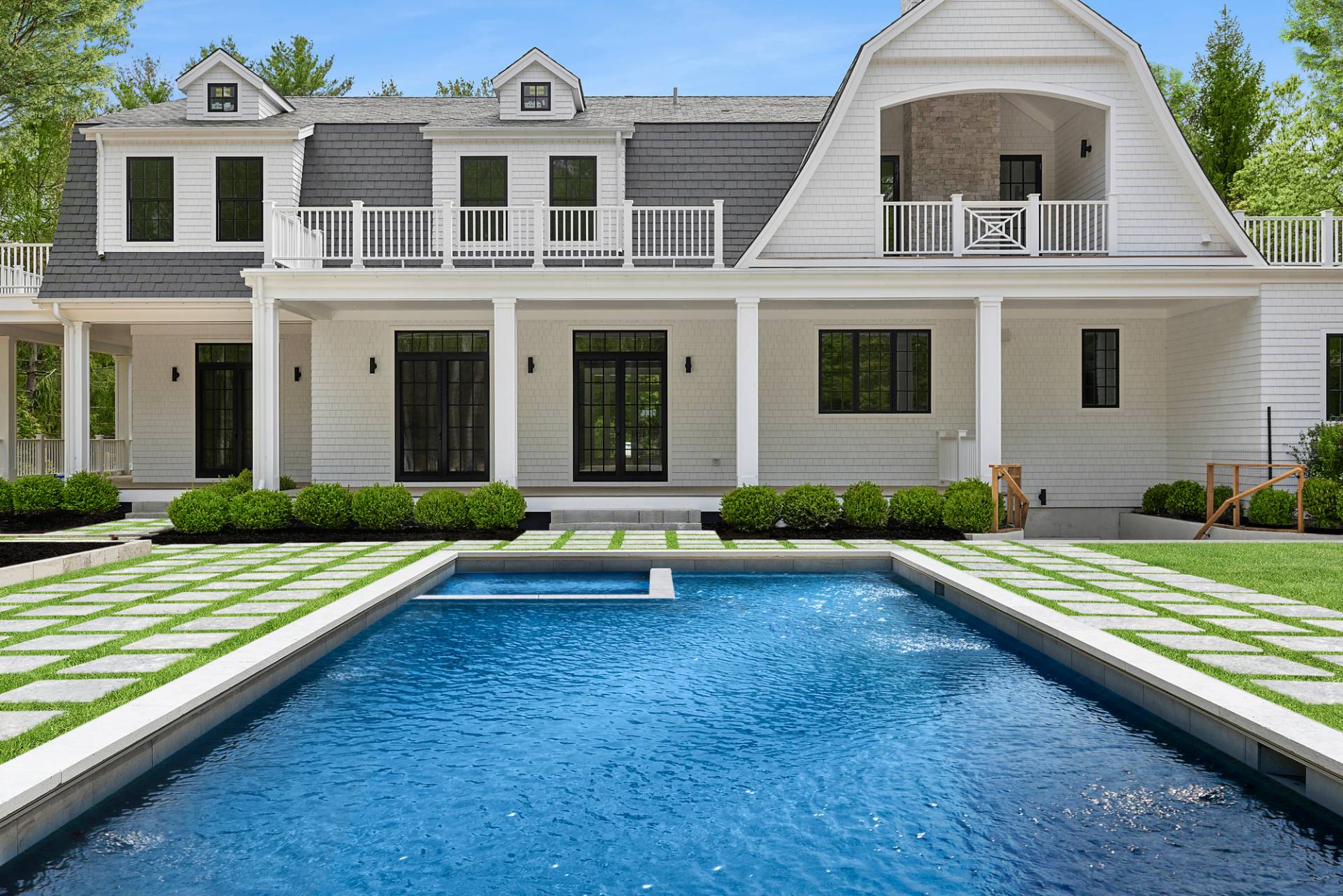 73 Wainscott Stone Road Wainscott, NY 11975 - Photo 3 of 27 a front view of a house with a yard