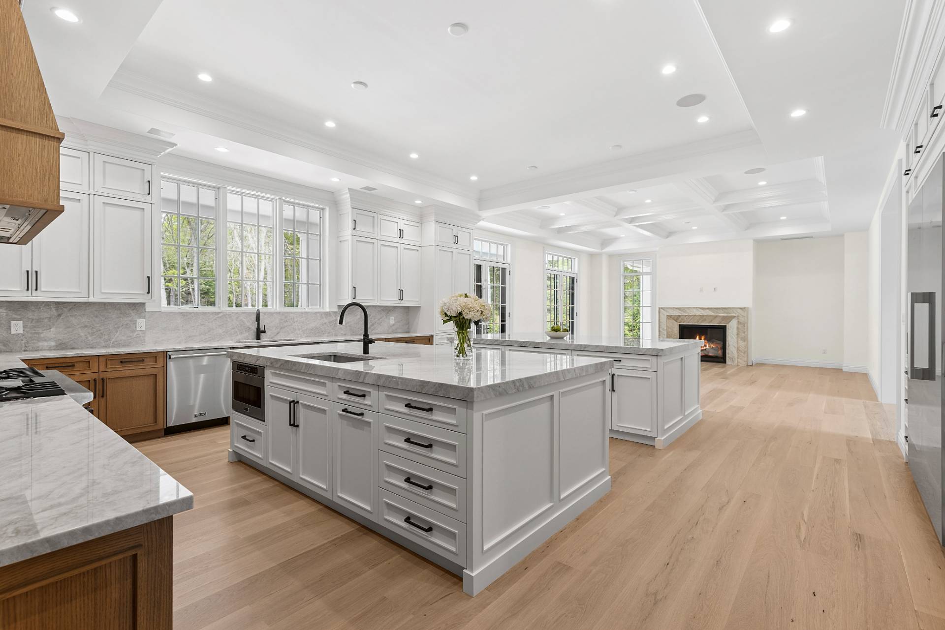 73 Wainscott Stone Road Wainscott, NY 11975 - Photo 5 of 27 a large white kitchen with stainless steel appliances granite countertop a stove and a sink