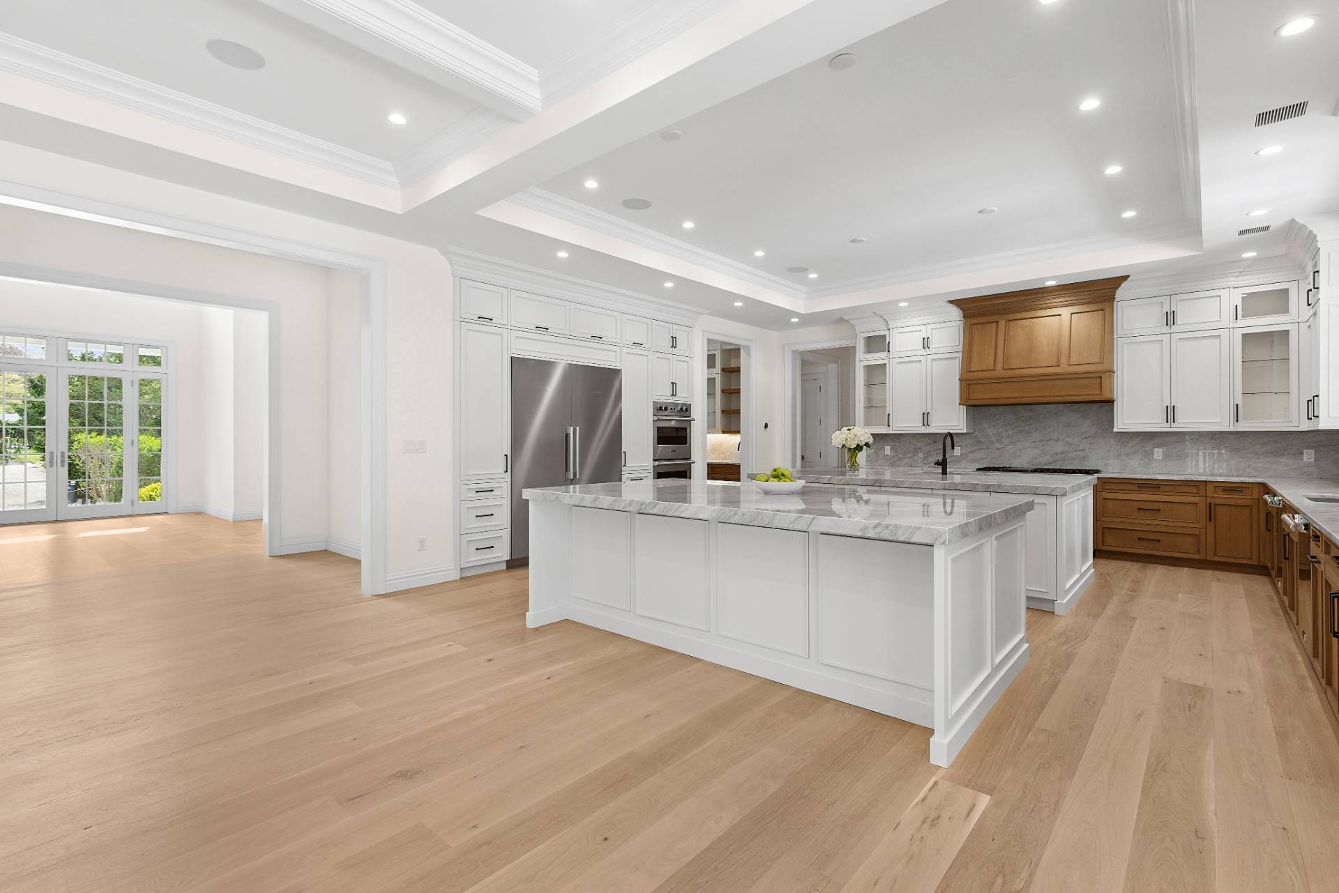 73 Wainscott Stone Road Wainscott, NY 11975 - Photo 6 of 27 a large kitchen with stainless steel appliances granite countertop a large counter top a stove a sink and a refrigerator