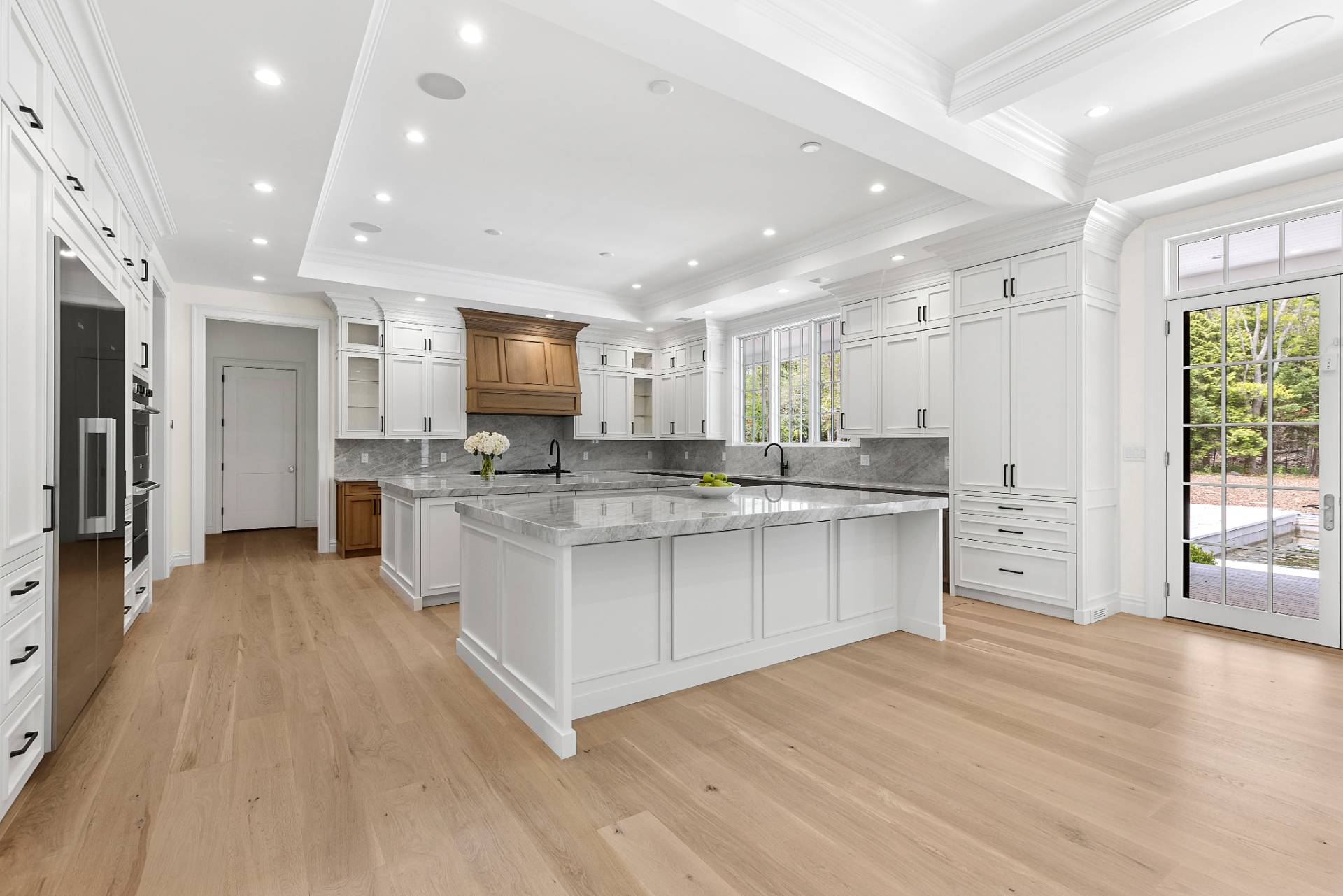 73 Wainscott Stone Road Wainscott, NY 11975 - Photo 7 of 27 a large kitchen with stainless steel appliances lots of white cabinets