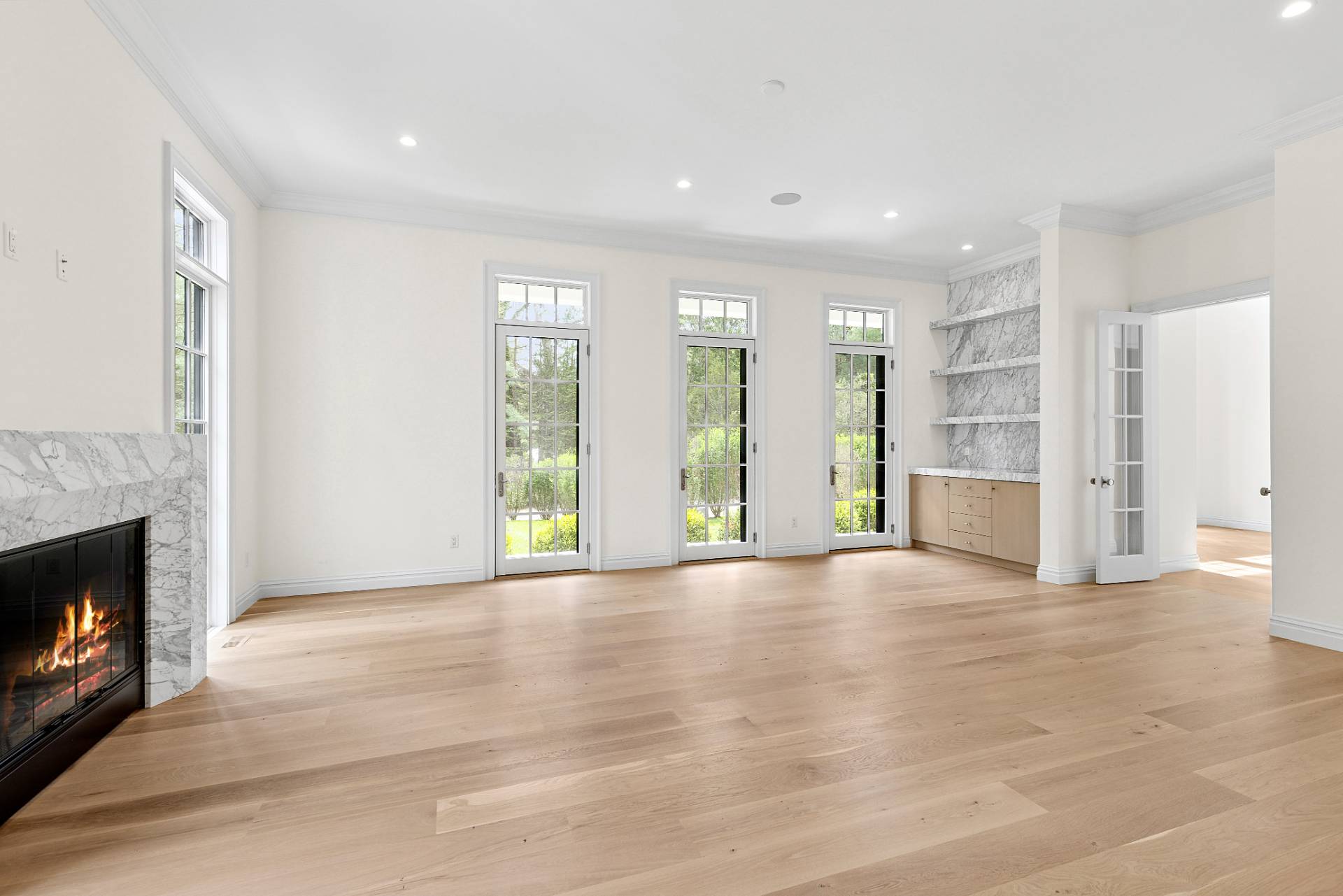 73 Wainscott Stone Road Wainscott, NY 11975 - Photo 9 of 27 a view of an empty room with a fireplace and a window