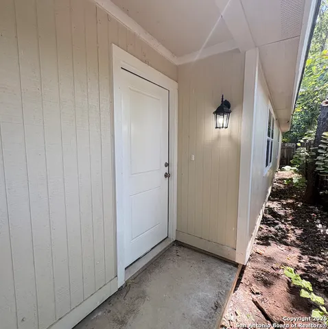 an entryway door with wooden floor
