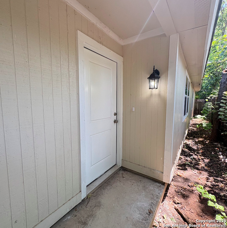an entryway door with wooden floor