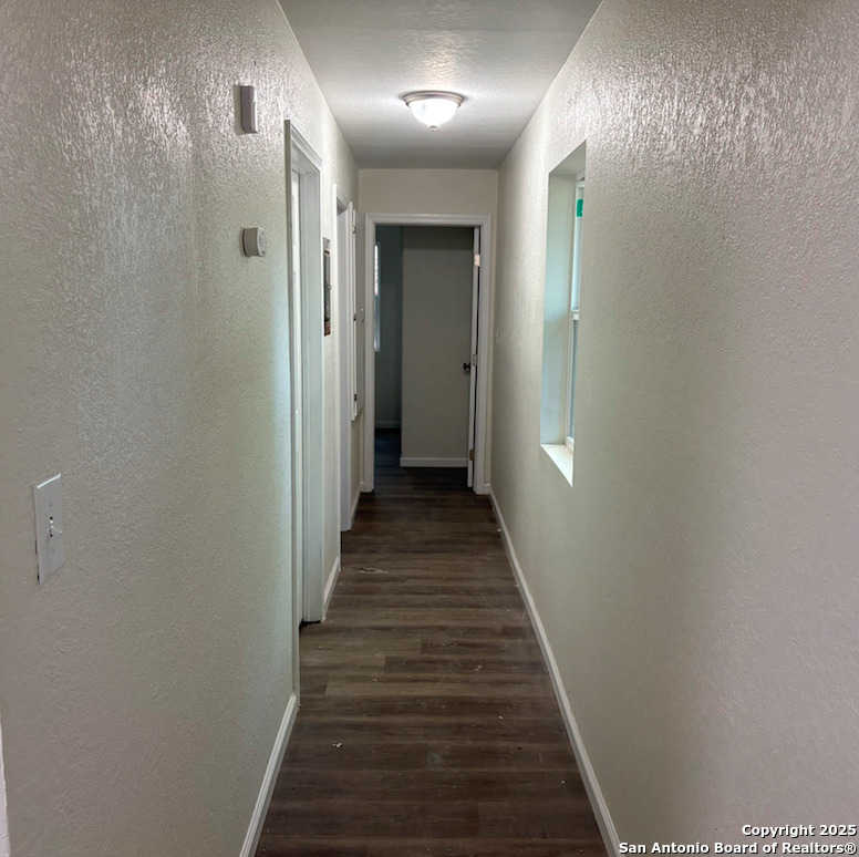428 North Vaughan Avenue, Unit 3 Seguin, TX 78155 - Photo 4 of 7 a view of a hallway with wooden floor