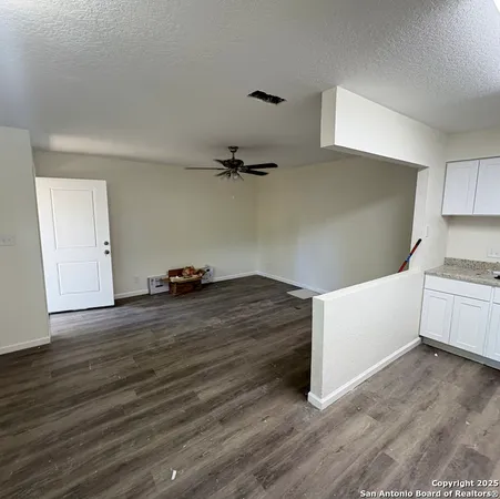 a view of a kitchen with wooden floor
