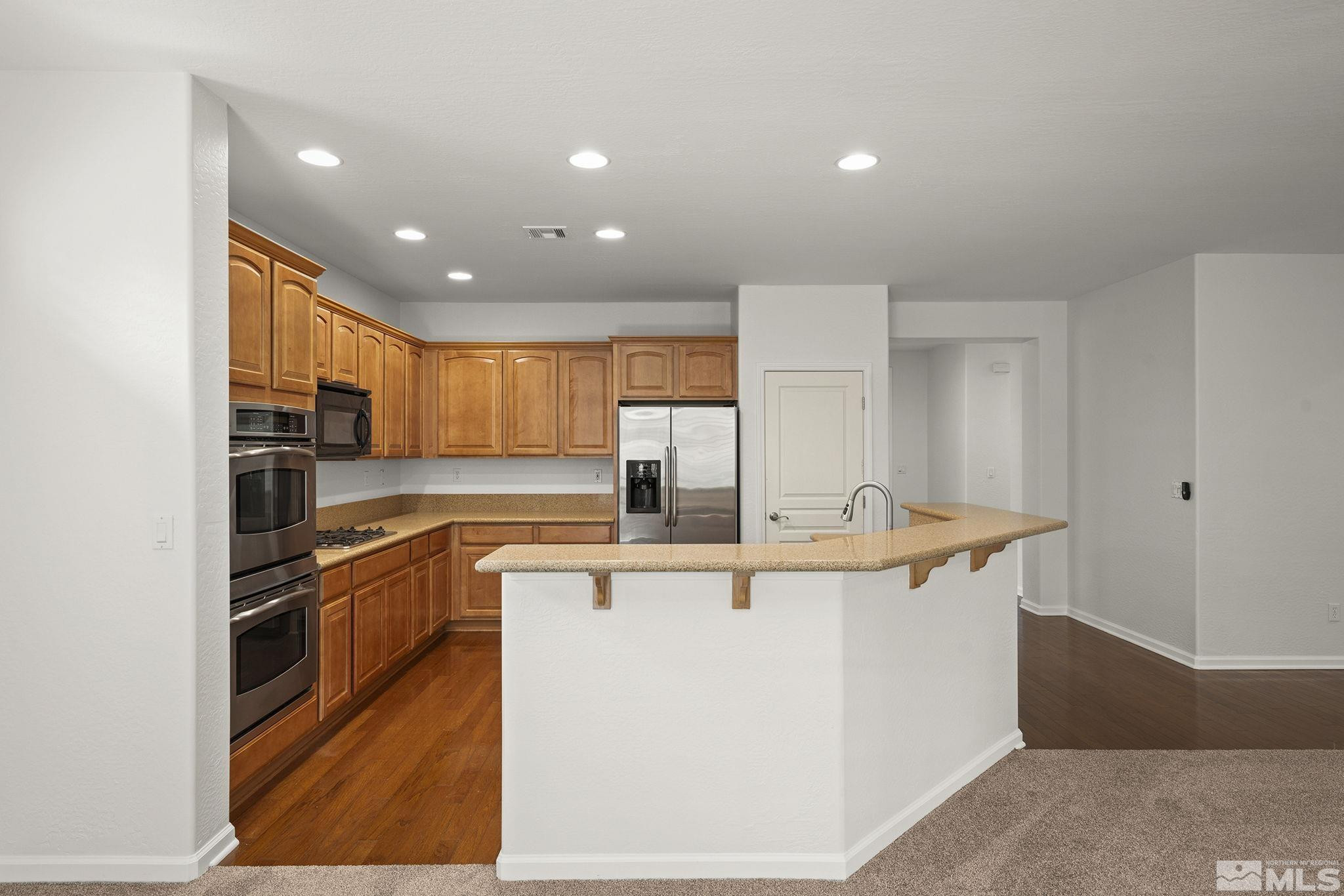 1280 Meridian Ranch Drive Reno, NV 89523 - Photo 13 of 41 a kitchen with stainless steel appliances granite countertop a sink and a refrigerator