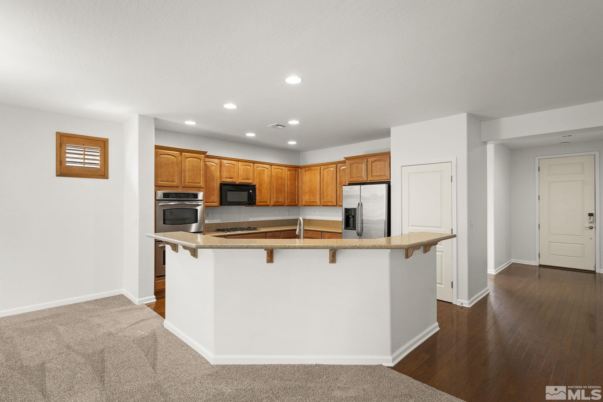1280 Meridian Ranch Drive Reno, NV 89523 - Photo 14 of 41 a kitchen with stainless steel appliances a refrigerator and a stove top oven