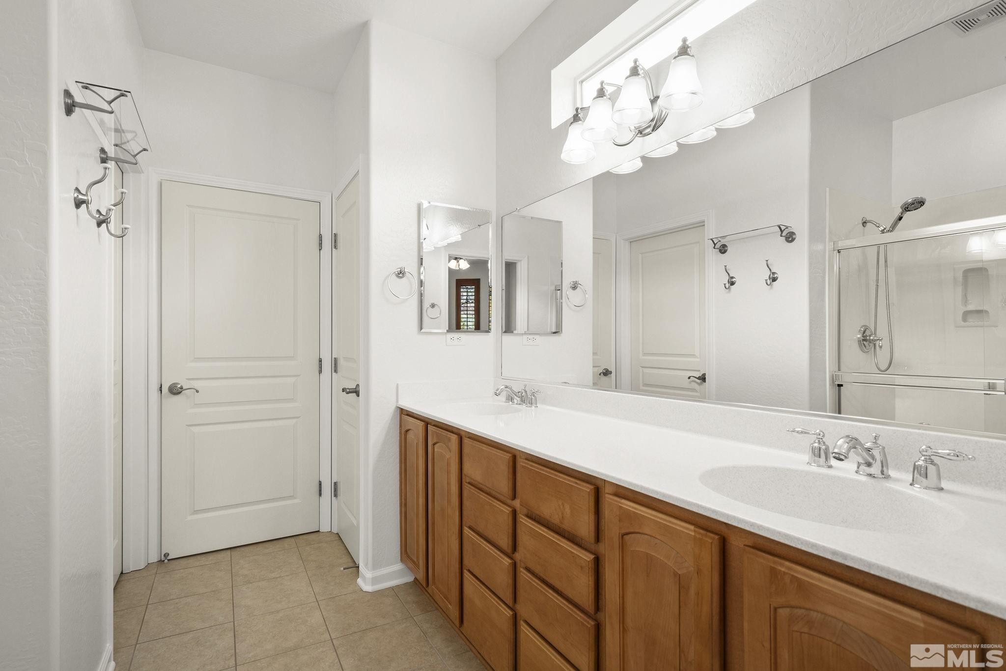 1280 Meridian Ranch Drive Reno, NV 89523 - Photo 18 of 41 a bathroom with a sink double vanity and a mirror