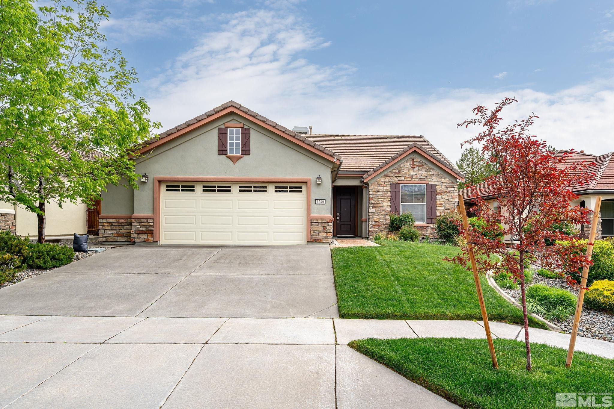 1280 Meridian Ranch Drive Reno, NV 89523 - Photo 2 of 41 a front view of a house with a yard and garage