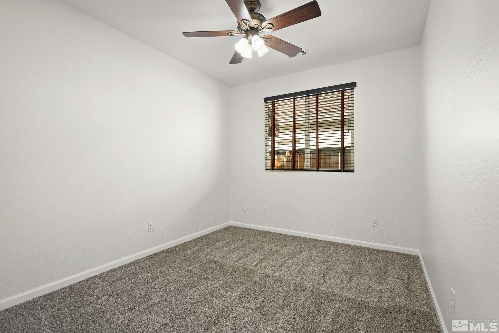 1280 Meridian Ranch Drive Reno, NV 89523 - Photo 24 of 41 an empty room with a window and a fan
