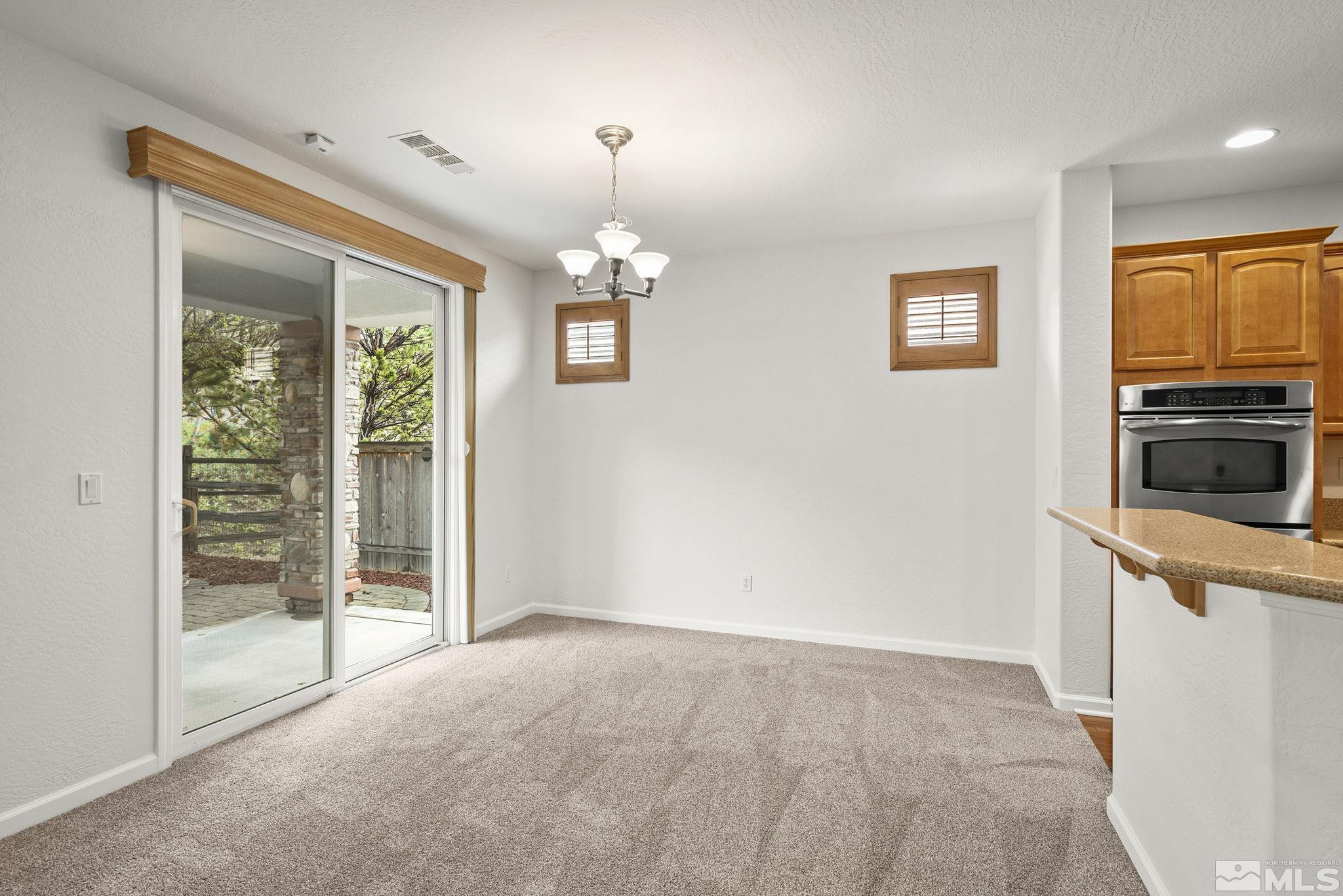 1280 Meridian Ranch Drive Reno, NV 89523 - Photo 6 of 41 an empty room with windows and cabinet