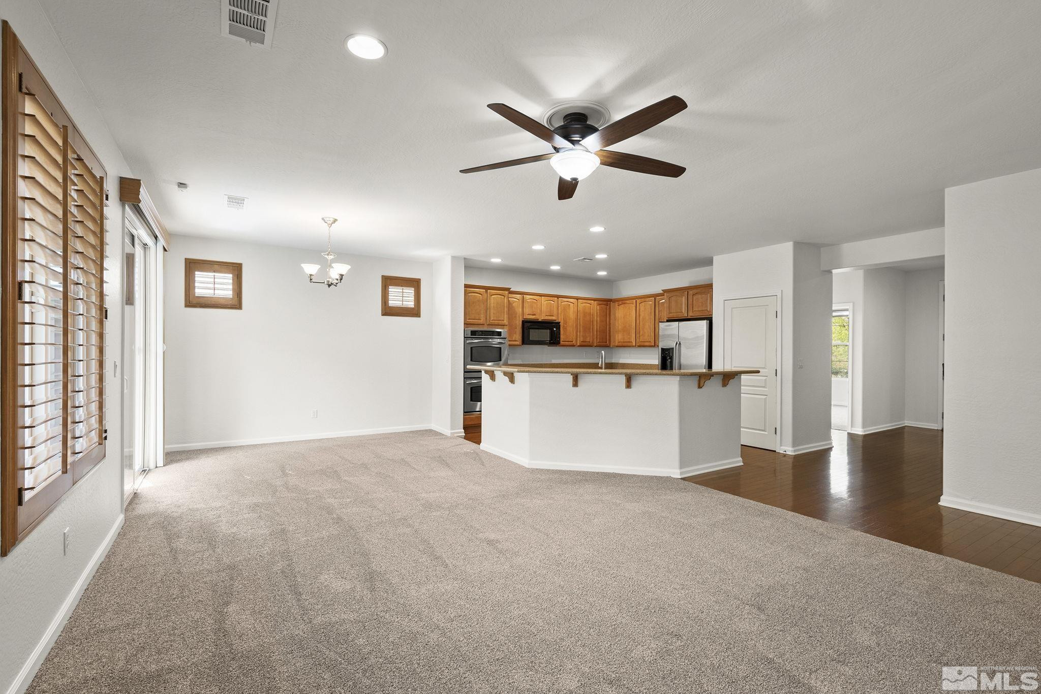 1280 Meridian Ranch Drive Reno, NV 89523 - Photo 8 of 41 a view of a big room with wooden floor and windows
