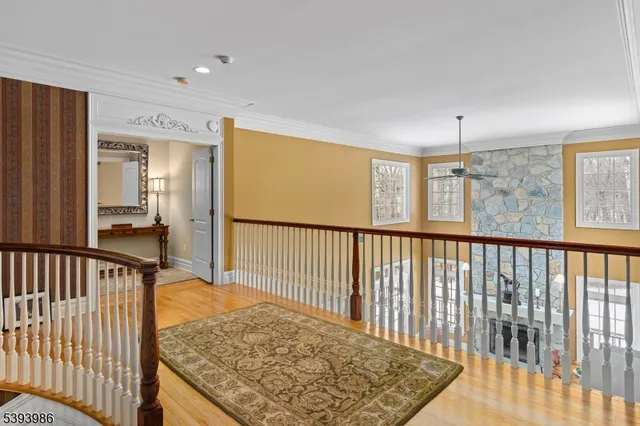 a view of hallway with a rug and a window