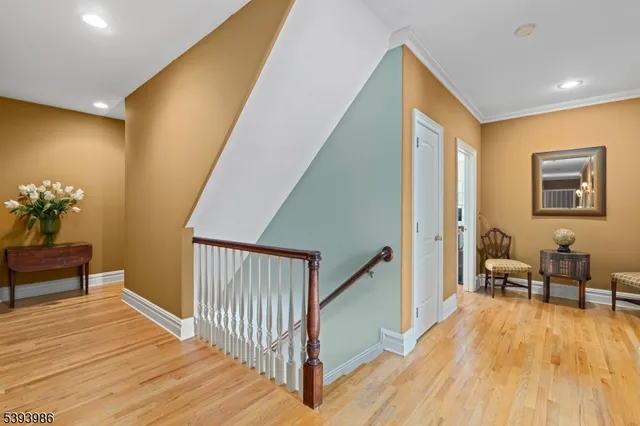 a view of a hallway with furniture and wooden floor