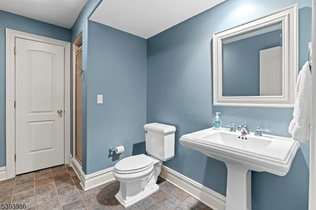 a bathroom with a sink a toilet and mirror