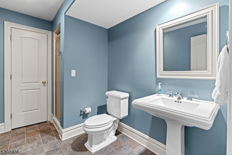 7 Timber Ridge Road Far Hills, NJ 07931 - Photo 42 of 49 a bathroom with a sink a toilet and mirror
