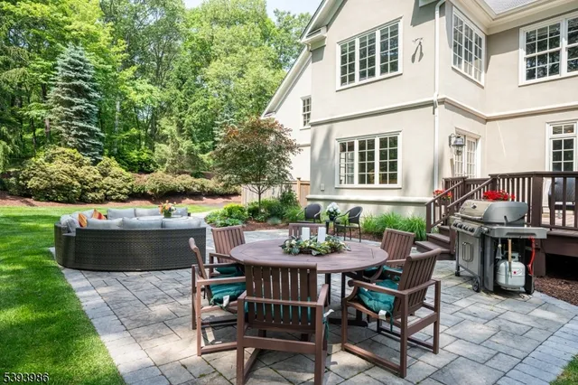 a view of house with a backyard and sitting area